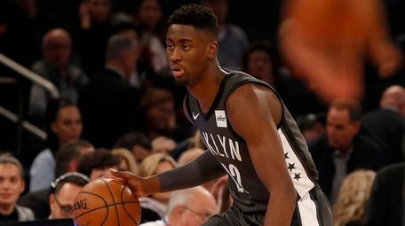 The Nets' Caris LeVert controls the ball during