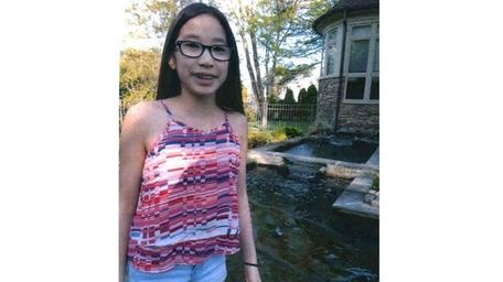 Kidsday reporter Mirabella Joa by her koi pond.