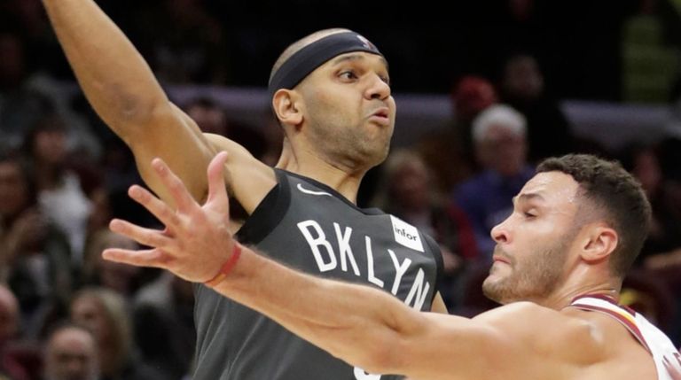 The Nets' Jared Dudley passes over the Cavaliers'