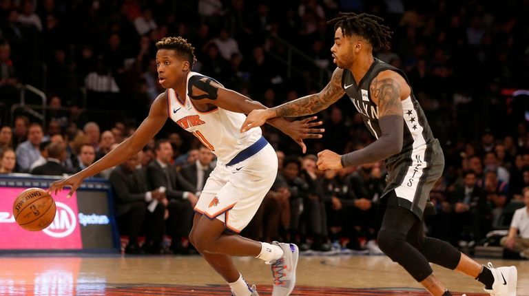 The Knicks' Frank Ntilikina drives past the Nets'