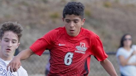Jeremy Guardado of Amityville scores a goal while