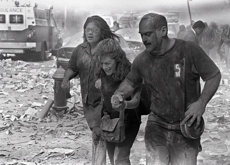 Julie McDermott, center, walks with other victims as
