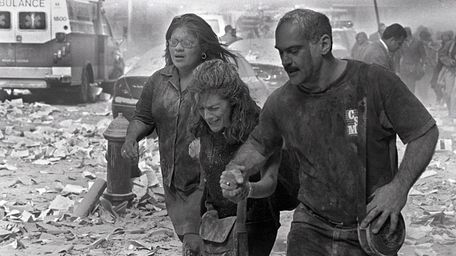 Julie McDermott, center, walks with other victims as
