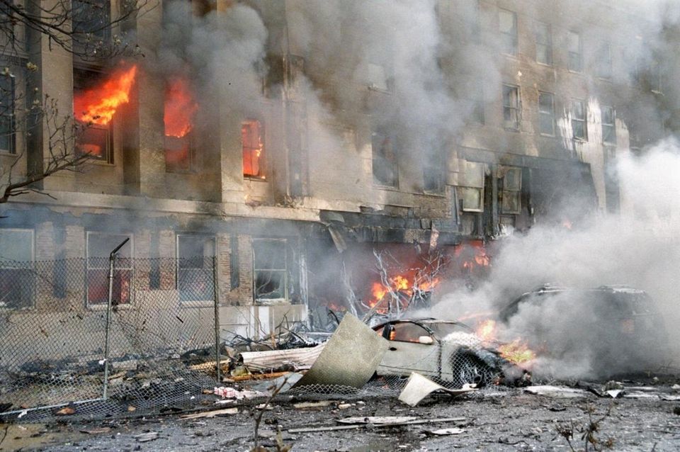 Flames and smoke pour from a building at