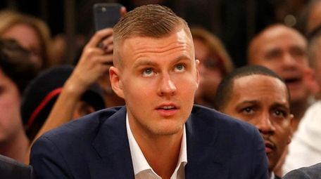 The Knicks' Kristaps Porzingis looks on from the