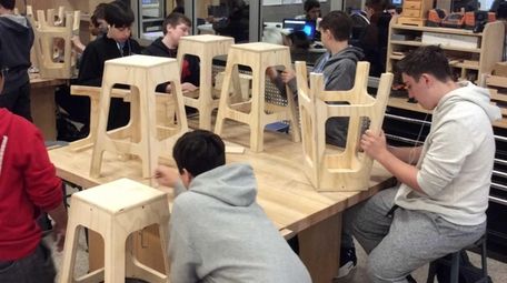 Mineola High School students create wooden stools in