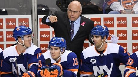Islanders coach Barry Trotz talks to some players