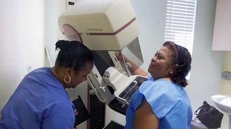 Toborcia Bedgood, left, prepares a screen-film mammography test