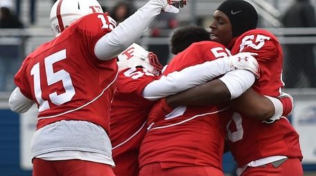 Freeport teammates celebrate after their 20-19 win over