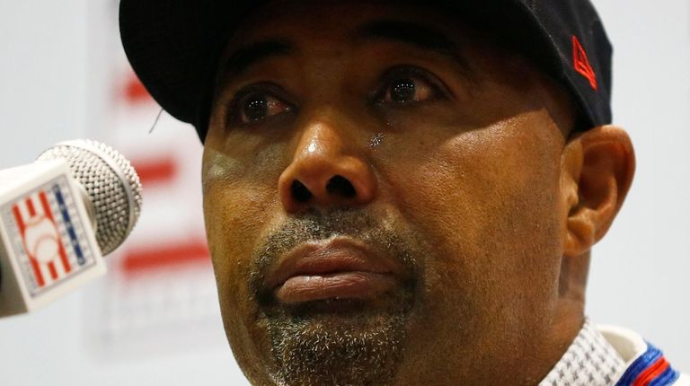 Harold Baines cries during a news conference for
