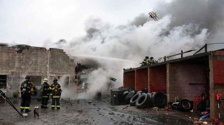 Firefighters work to extinguish a fire at a