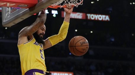 The Lakers' Tyson Chandler dunks over the Heat's