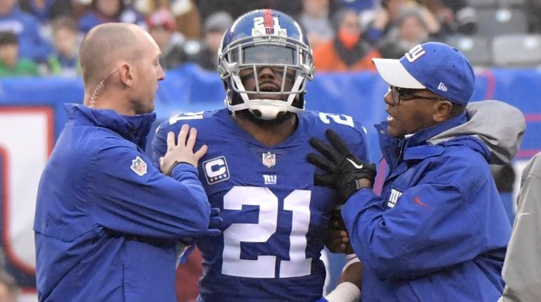 Giants strong safety Landon Collins is assisted by
