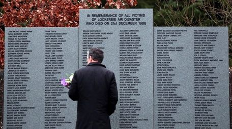 A man on Friday looks at a memorial