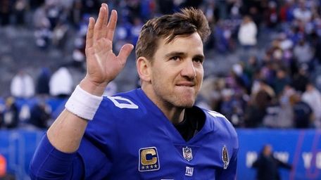 Giants quarterback Eli Manning runs off the field