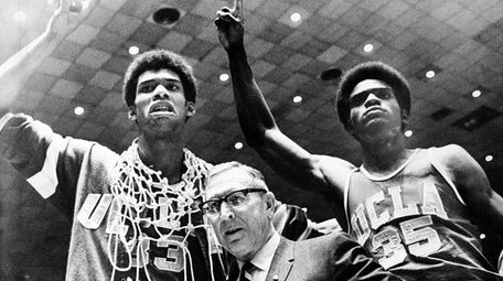 UCLA coach John Wooden is flanked by Sidney