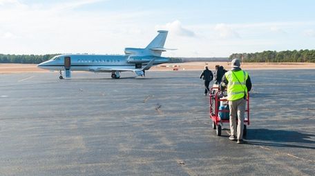 Luggage is taken to a jet at East