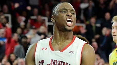 St. John's Mustapha Heron celebrates his dunk against