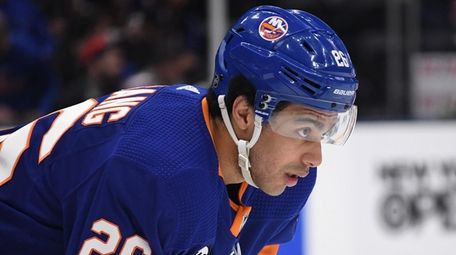 Islanders right wing Josh Ho-Sang looks on before