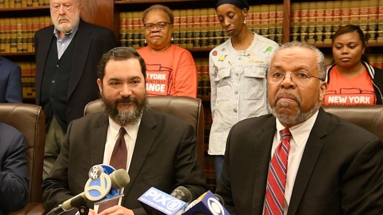 Hempstead schools Superintendent Shimon Waronker and his attorney,
