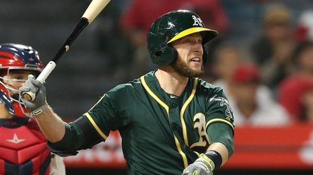 A's second baseman Jed Lowrie watches his hit