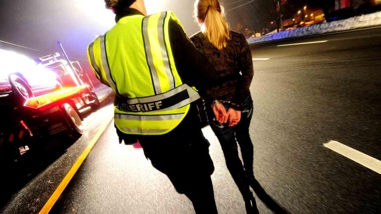 A female driver is arrested on DWI charges