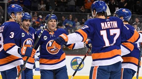 The Islanders' Cal Clutterbuck, second from left, celebrates