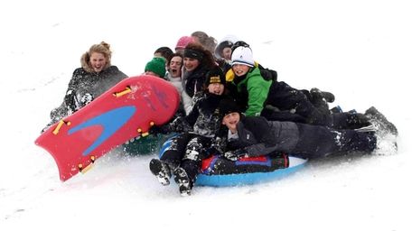Sledders take advantage of the snow in Cedar