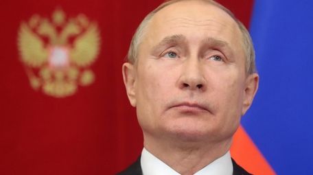 Russian President Vladimir Putin attends a signing ceremony
