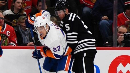Islanders lineman Anders Lee fights for the puck