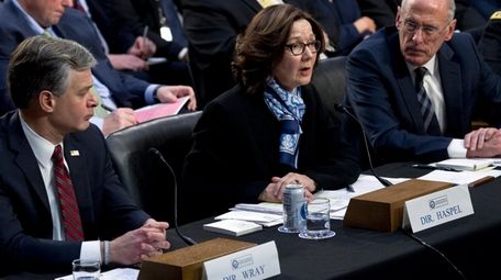 FBI Director Christopher Wray, left, CIA Director Gina