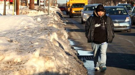 Some Long Island sidewalks are still covered with
