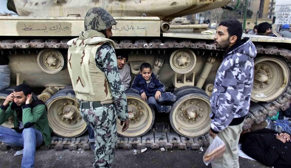 Anti-government protesters sit inside the tracks of Egyptian