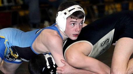 Hauppauge's Nick Mauriello, top, competes in a wrestling
