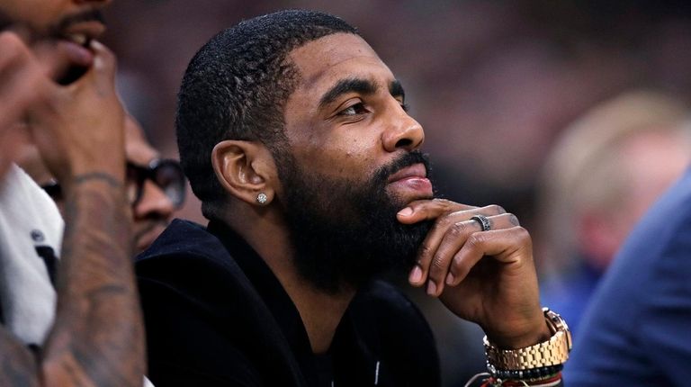 Celtics guard Kyrie Irving watches play from the