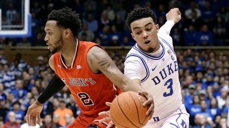 Duke's Tre Jones reaches for the ball while