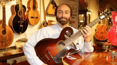 The American Guitar Museum's owner, Chris Ambadjes, poses