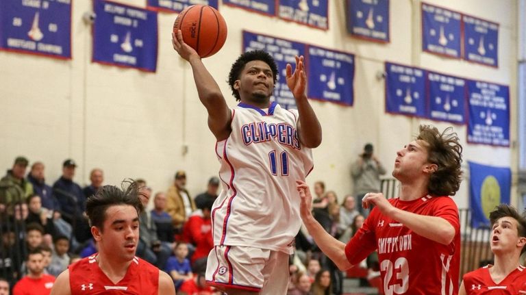 Jaylen Trent #11 of Bellport goes up for