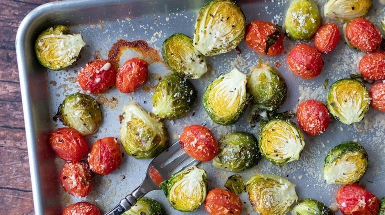 Brussels sprouts and grape cherry tomatoes are tossed