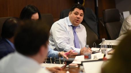 George Tsunis, center, is running Nassau University Medical