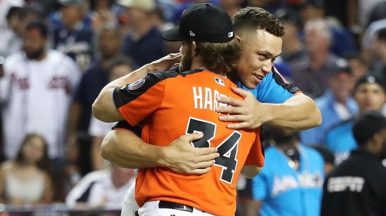 Aaron Judge of the Yankees hugs Bryce Harper