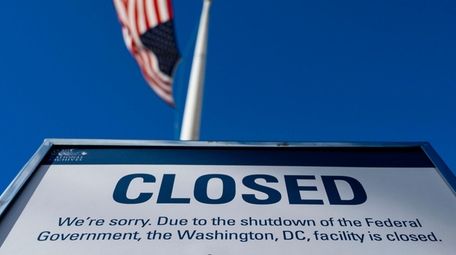 A sign is displayed on a government building