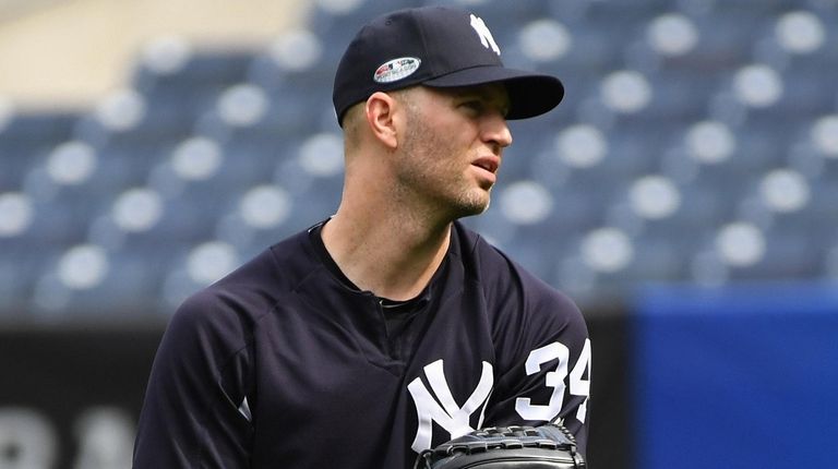 Yankees pitcher J.A. Happ throws during the American