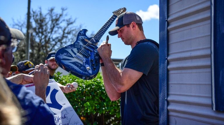 Yankees pitcher Zack Britton sign autographs for fans
