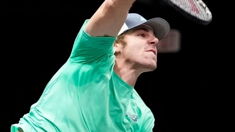 Reilly Opelka follows through on his serve against