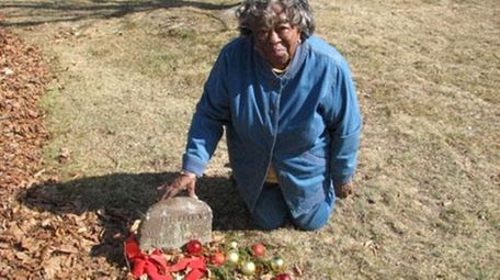 Eleanor Lingo, 84, of Southold, visits the grave