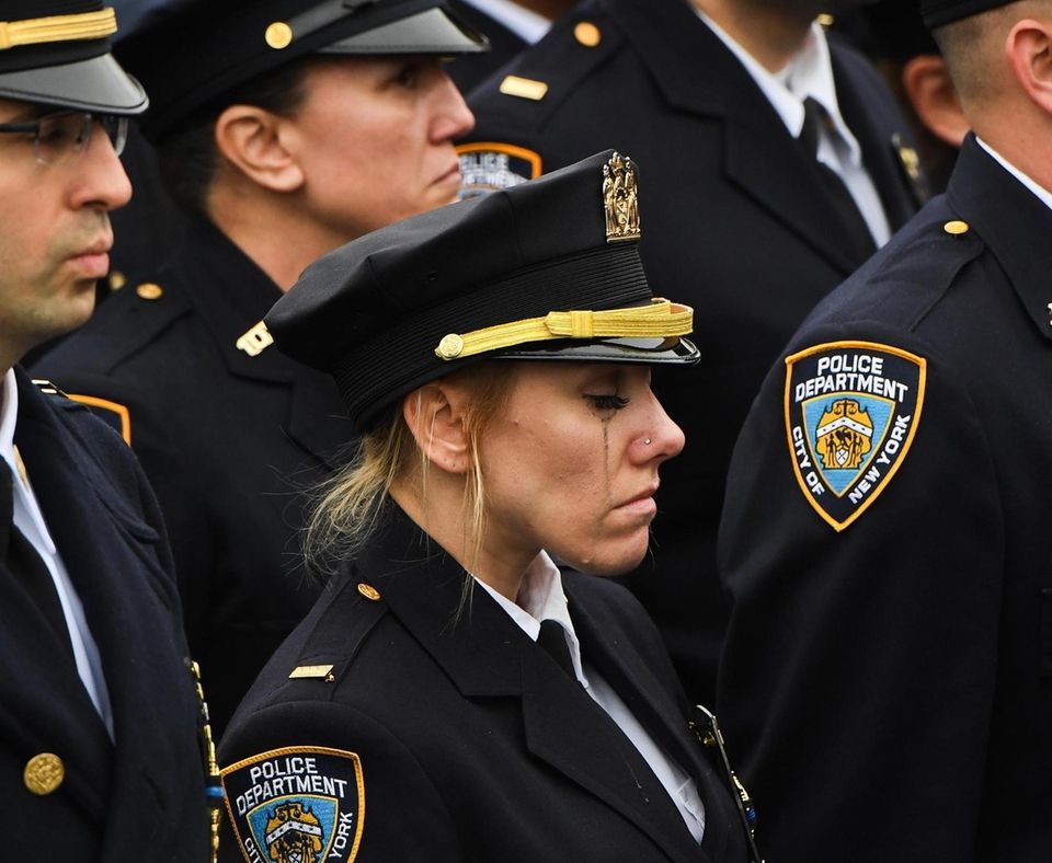 NYPD police officers from the 102 pct. gather