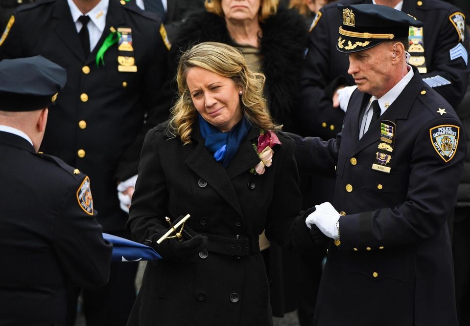 Leanne Simonsen is presented the memorial flag in