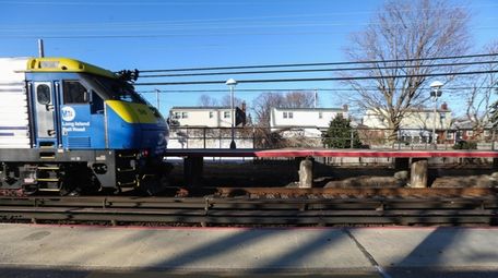 Looking north, a westbound train passes through the