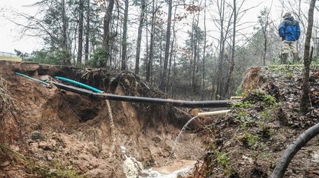 Hunter Maples looks over a water line break